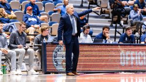 UNF heaf basketball coaches pointing and yelling during a game.