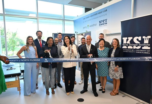 UNf faculty cutting ribbon.