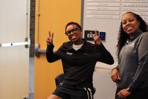 Jayla Adams holding up "peace" sign for the photo.